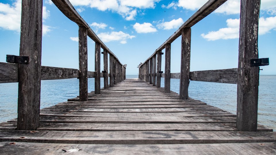 Symmetrical photo down a wooden dock