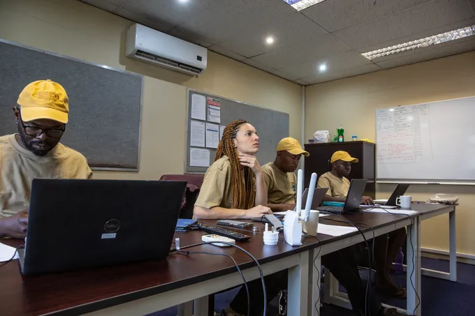 Pilots preparing for survey flight in an indoor classroom setting.