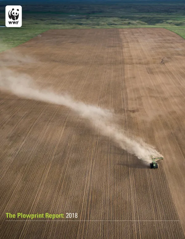 A report cover with an aerial view of plowed up grassland and a green tractor spewing dust as it travels across the dirt