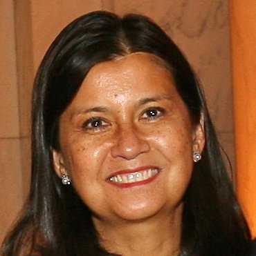 A headshot of a smiling woman