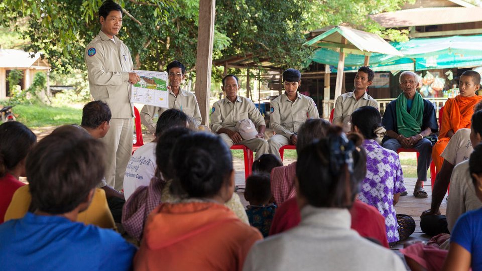 Dorn Bann (47), deputy head of Anlung Cheauteal River Guard Post stands in front of community members during a meeting