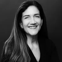 A black and white headshot of Rebecca. She is a white woman with long hair.