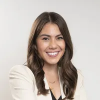 Portrait of Rebecca Homan who has brown hair and brown eyes and is wearing a white blazer