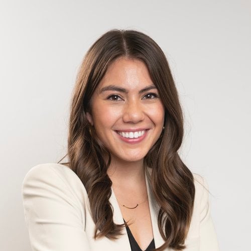 Portrait of Rebecca Homan who has brown hair and brown eyes and is wearing a white blazer