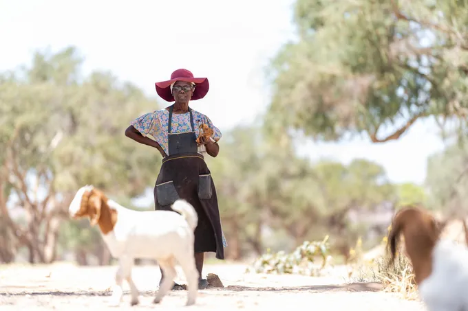 Rebecca Adams with a pair of her goats outside De Riet village, Namibia
