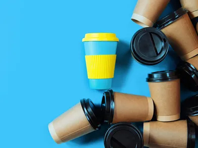 One reusable coffee cup stands out among paper and plastic disposable cups