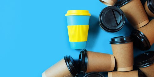 One reusable coffee cup stands out among paper and plastic disposable cups