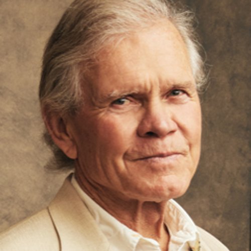 Headshot of Rick Ridgeway wearing a tan blazer