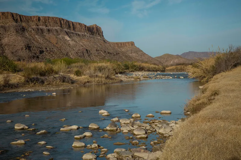 The Rio Grande river with cliffs in background