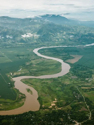 Aerial photo of a valley with a meandering river flowing down from mountains