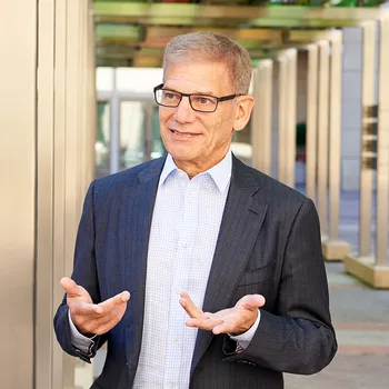 Robert Litterman wearing a suit and gesturing with his hands