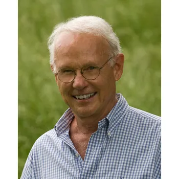 Headshot of Roger W. Sant wearing a collared shirt against green background