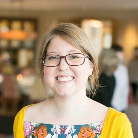 A headshot of a smiling woman