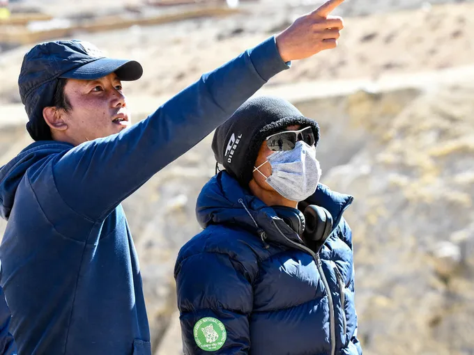 Samundra Subba points upward as another person looks on