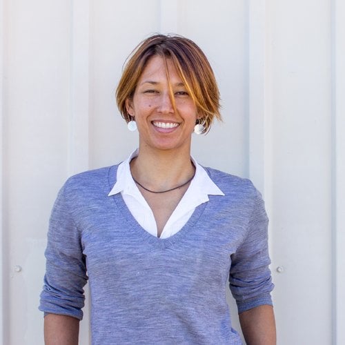 A photo of a smiling, well dressed but casual woman
