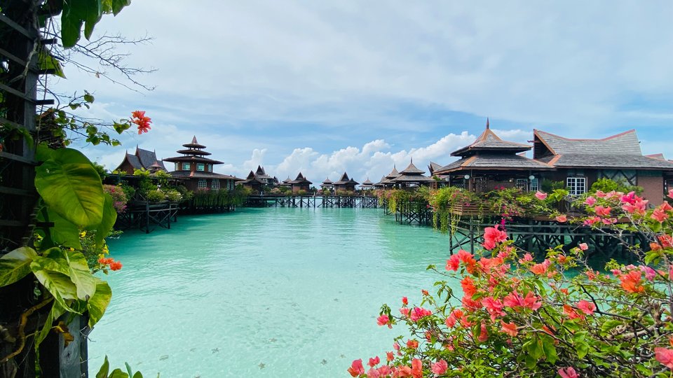 Small buildings on stilts in clear water