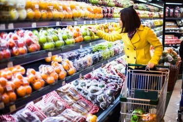 Person shopping in the produce aisle of grocery store