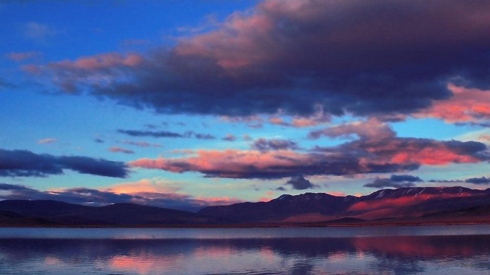 A pink and blue sunset over the high mountains