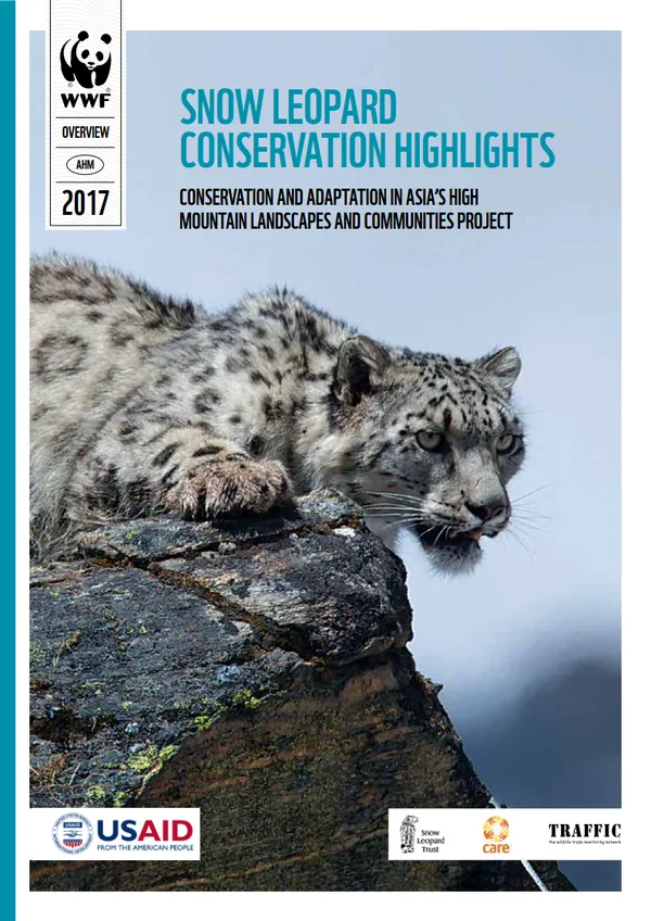 A report cover with a snow leopard crouching on a brown rock looking off camera