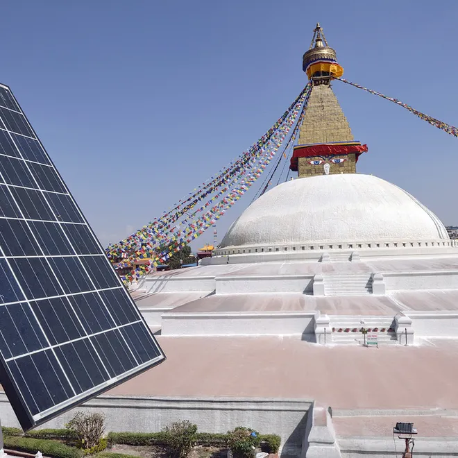 Solar panel on a roof top over looking a Buddhist shrine, Bodhnath Stupa in Kathmandu, Nepal