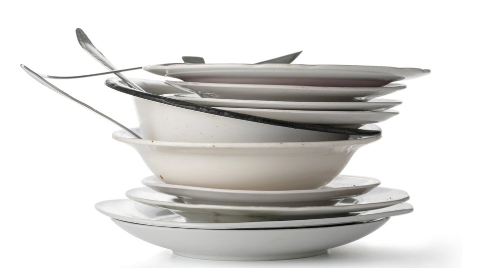 A stack of dirty dishes and utensils
