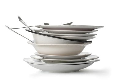 A stack of dirty dishes and utensils
