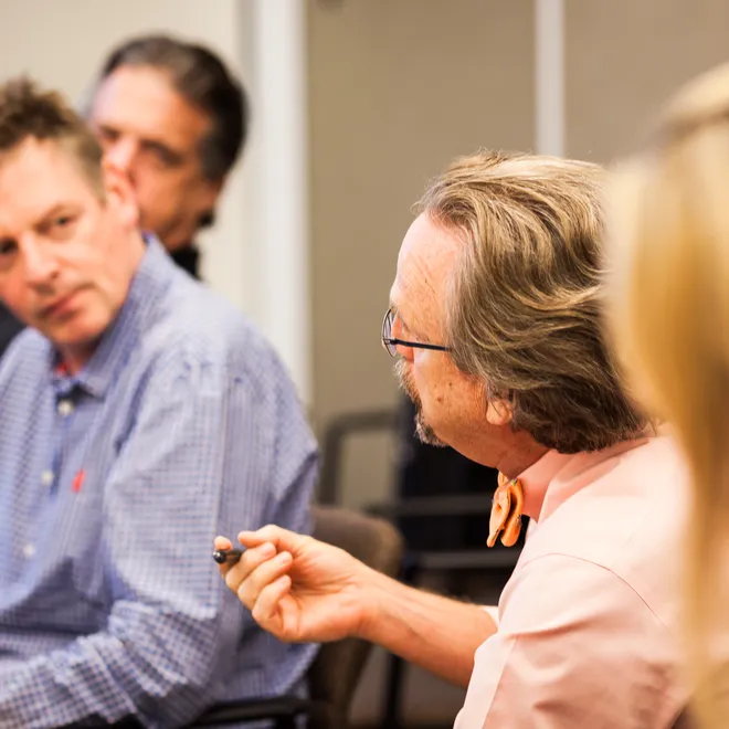 People in a conference room in deep conversation