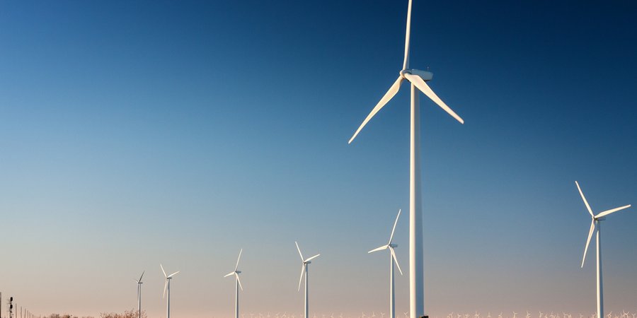 Tall wind turbine in a West Texas cotton field. Part of a larger wind farm.