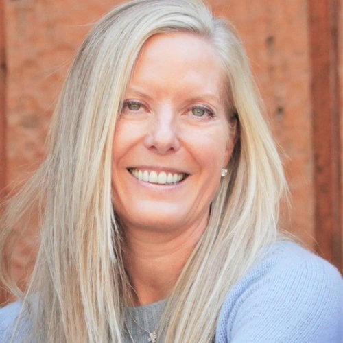 Headshot of Tammy smiling. She has long blond hair and is wearing a light blue sweater.