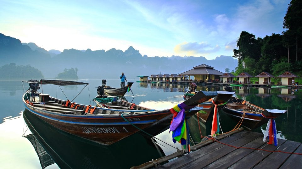 Boats on a river with forest in the background