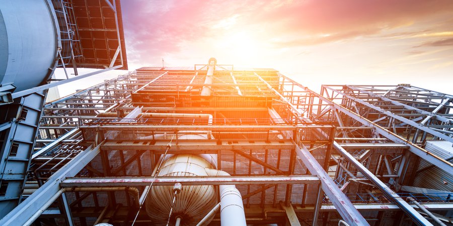 Internal structure of a larger thermal power plant with metal pieces and a bright sky