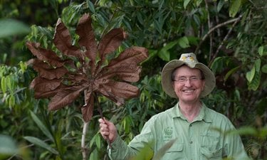 Thomas Lovejoy holding large leaf