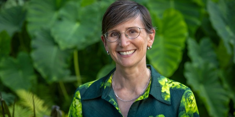 Toddi Steelman in front of green plants