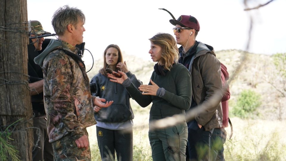 Valerie Weiss speaking with an actor on set