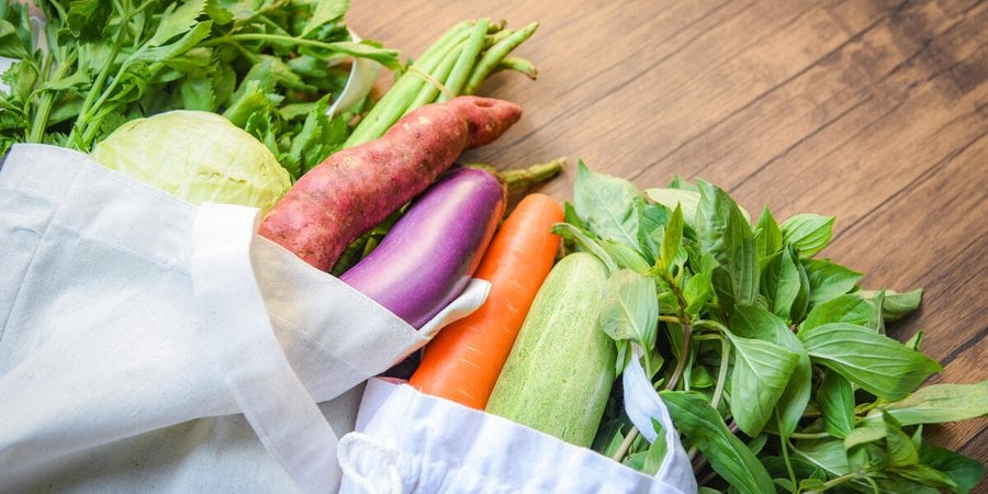 Vegetables in a tote bag on a counter
