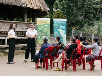 Two women give outdoor presentation