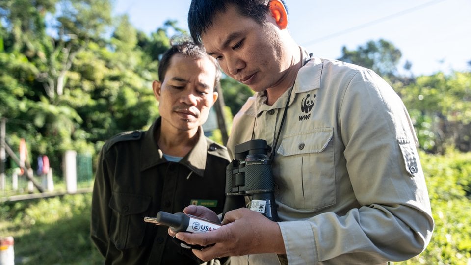 Rangers consult GPS in forest reserve