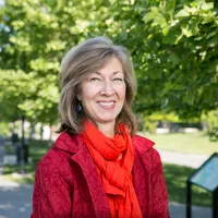 Headshot of Anita van Breda with trees and path in background