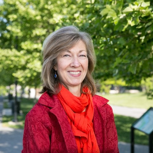 Headshot of Anita van Breda with trees and path in background