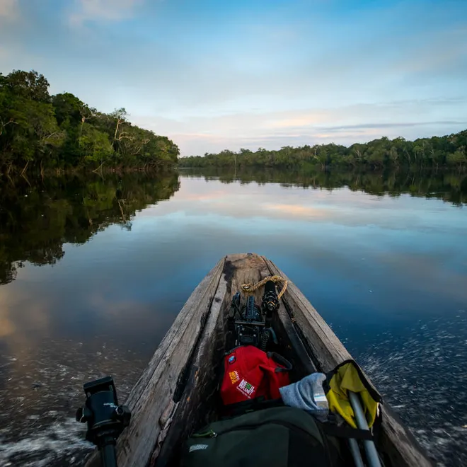 View from a canoe showing the prow and the still river beyond