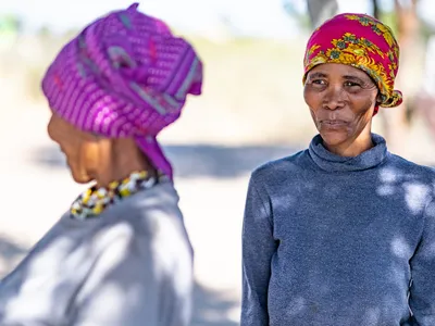 |uce Kxao stands outside in Nam Pan Village, Nyae Nyae Conservancy, Namibia