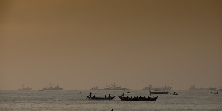 Fishermen on artisanal fishing boats, out at sea, Tema, Ghana.