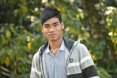 Portrait of a man against a green leafy background