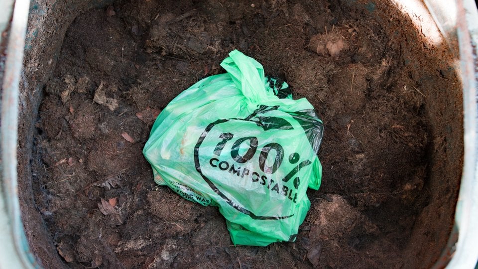 a plastic bag labeled "100% compostable"