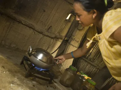 Kinu Darai cooking with bio-gas in her family home.