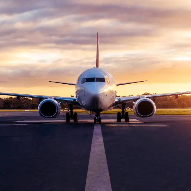 Sunset view of airplane on airport runway under dramatic sky in Hobart,Tasmania, Australia.