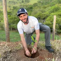 Matheus De Nardo planting a tree or other plant