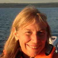 Gina De Ferrari in a life vest with water in the background