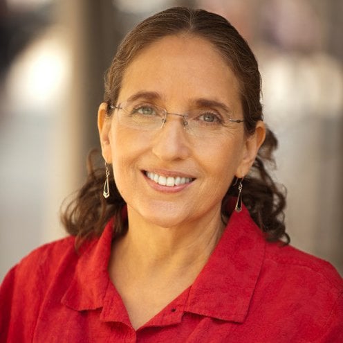 Headshot of Ruth Defries wearing a red shirt