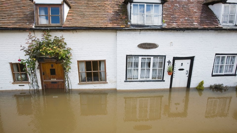 Flooding in England, houses covered in water.